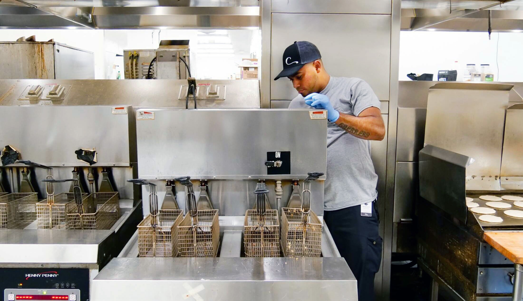 service tech inspecting deep fryer